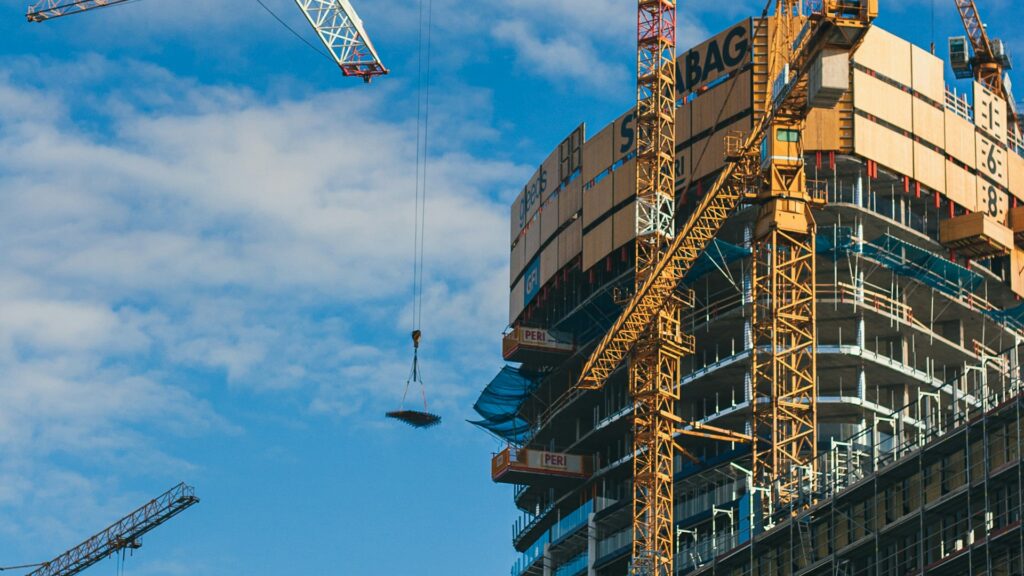 Tower cranes over a residential building under construction