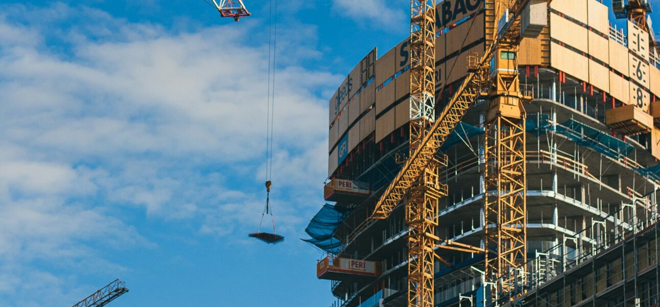 Tower cranes over a residential building under construction